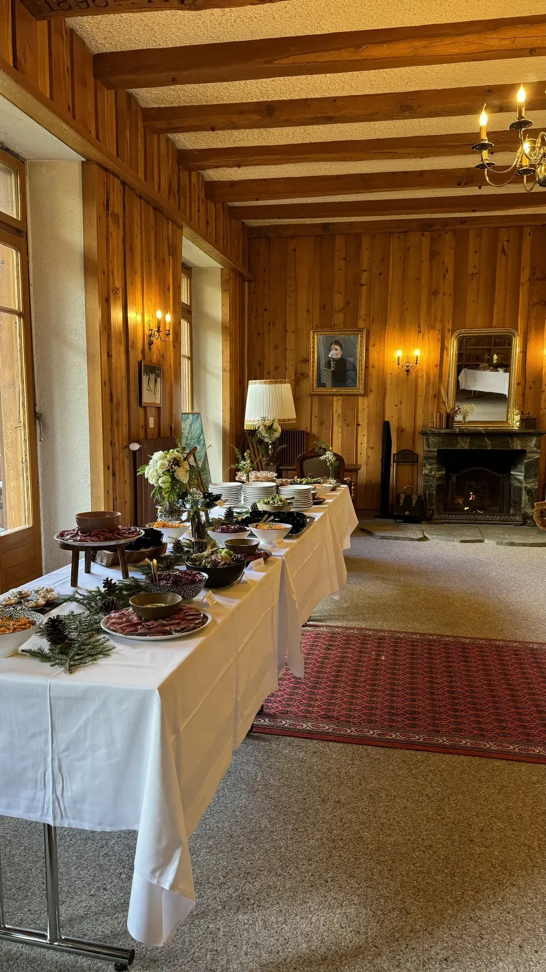 Buffet of local produce laid out in the historic lounge, beneath the portrait of Honorine — Grand Hôtel & Kurhaus Arolla